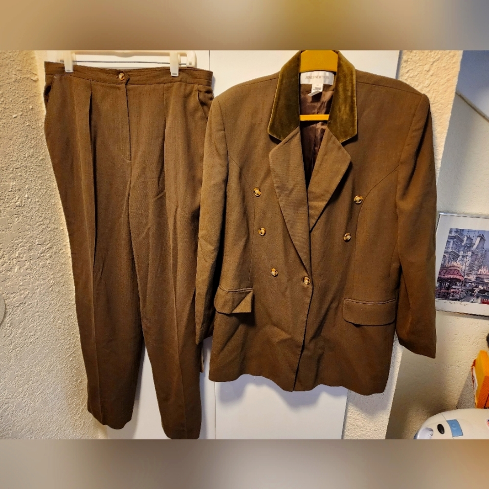 Suit is olive green with a velvet trimmed collar. Pleated pants, zipper.